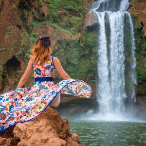 Beautiful waterfall in Morocco. Back woman beautiful dress looking fall Ouzoud Grand Atlas. Exotic nature North Africa